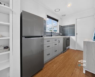 Modern kitchen featuring sleek appliances, ample storage, and a bright, inviting atmosphere perfect for cooking.
