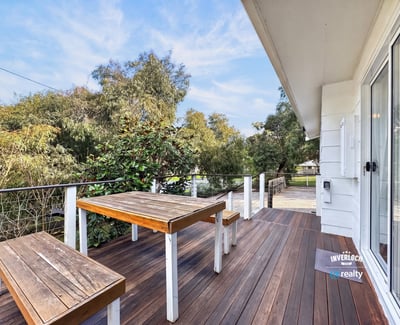 Expansive outdoor deck offers scenic views, perfect for entertaining or relaxing amidst nature.