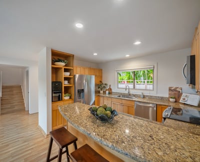 Bright kitchen featuring modern appliances, ample counter space, and a welcoming atmosphere for gatherings.