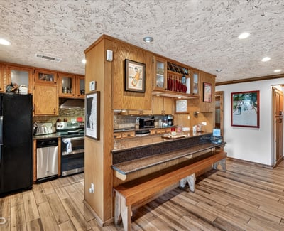 This inviting kitchen features ample cabinetry, modern appliances, and a cozy breakfast bar for casual dining.