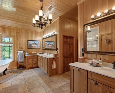 Spacious bathroom with natural wood accents, dual vanities, and a soaking tub for relaxation.