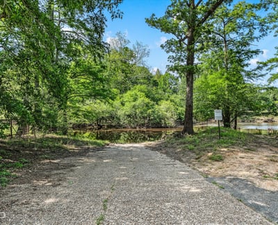 Private boat launch into Dorcheat Bayou, surrounded by lush greenery and tranquil views.