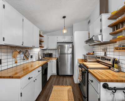 Modern kitchen featuring sleek cabinetry, butcher block countertops, and ample storage for all your culinary needs.