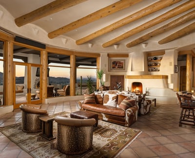 A stunning combination of rustic design and refined finishes, this great room features a striking fireplace, handcrafted details, and abundant natural light. Terracotta flooring and curved adobe walls complete this desert-inspired masterpiece.