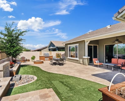 The covered patio and landscaped yard create an inviting outdoor extension of the home, perfect for entertaining, dining, or quiet evenings in Phoenix.
