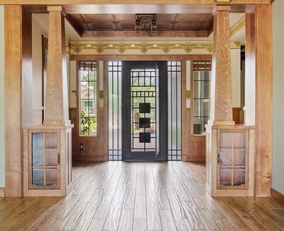 Inviting entryway showcasing handcrafted woodwork, built in storage, and a custom iron front door. This Phoenix home delivers standout architectural style and premium craftsmanship from the moment you arrive.