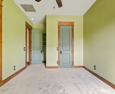 Well-proportioned bedroom with custom trim details, neutral tones, and inviting natural light. Ideal for flexible living arrangements or guest accommodations.