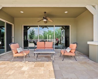 Stay cool and comfortable on this covered patio featuring ceiling fan, shade, and seamless flow to the yard ideal for Phoenix s sunny days and desert evenings.
