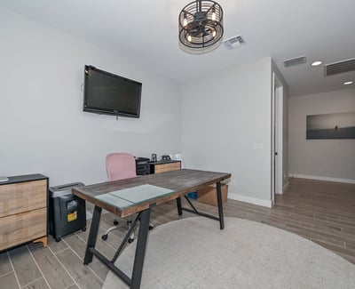 Tucked away for quiet productivity, this smartly designed den offers comfort and style with recessed lighting and modern finishes.