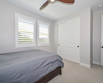 This inviting second bedroom offers dual windows, clean finishes, and functional layout ideal for versatile living in Peoria.