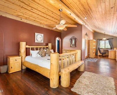 Open-concept owner s suite with loft-style design, hardwood floors, and handcrafted log details that create a serene private retreat.