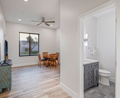 A private bedroom with en-suite bath provides comfort and independence for guests or family members.