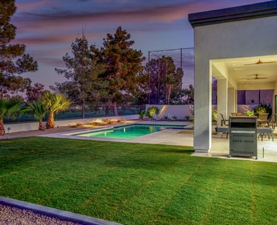 Backyard oasis with pool, lush lawn, and covered patio. A perfect Scottsdale retreat designed for relaxation and entertaining.