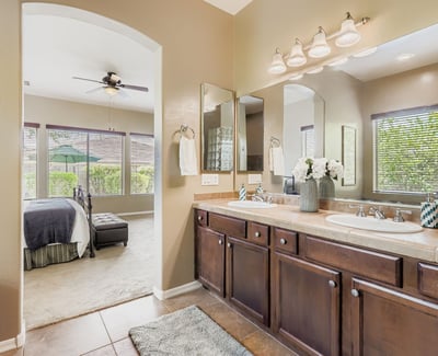 Double vanity with extensive cabinetry and updated mirrors ensures both convenience and elegance in the primary bath.