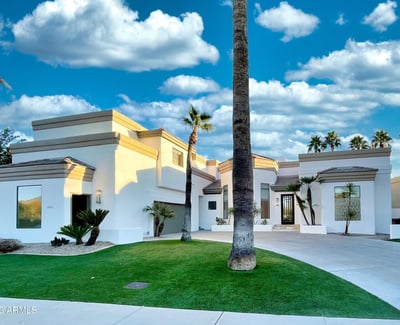 Modern white fa ade accented with desert greenery and bold rooflines. A perfect fusion of clean design and timeless elegance.