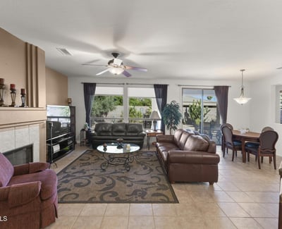 Expansive windows brighten this inviting living space, highlighting the seamless connection to the private backyard and showcasing the best of Arizona indoor-outdoor living.