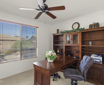 This dedicated office space offers natural light, built-in shelving, and quiet ambiance perfect for working from home in comfort and style.