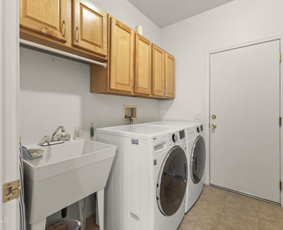 Practical utility area with wash basin, upper storage, and workspace designed to simplify cleaning and maintenance tasks.