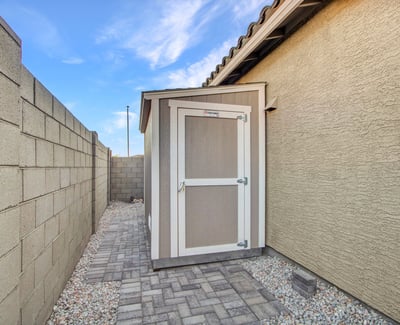 A sturdy exterior shed expands storage options, perfect for organizing tools and equipment in this Litchfield Park property.