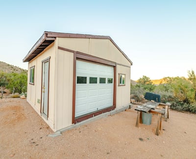 This durable workshop provides ample space for projects, tools, and storage. Surrounded by desert landscape and mountain horizons, it enhances the property s rural functionality.