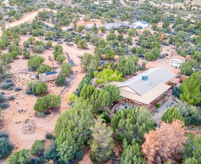 This sweeping shot captures the vast desert landscape and dramatic mountain ridge. The perfect visual representation of the tranquility and beauty surrounding this Hackberry property.