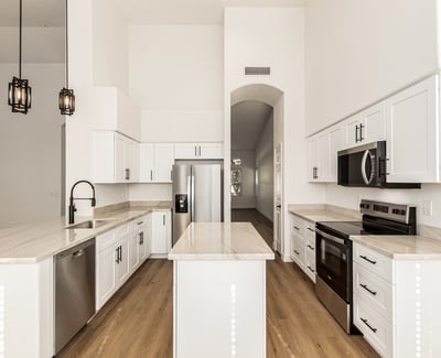 Beautiful center view of the remodeled Scottsdale kitchen showcasing clean cabinetry, stainless steel appliances, and a large center island. The open design makes this kitchen ideal for both cooking and entertaining.