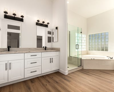 Elegant primary bathroom featuring dual sinks, modern cabinetry, and contemporary lighting. The Scottsdale bathroom connects to a spa-like shower and soaking tub for everyday comfort.
