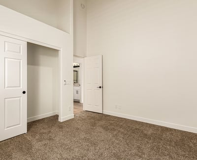 Additional bedroom with natural light, plush carpet, and neutral tones. The flexible Scottsdale space works well as a guest room, office, or additional living area.