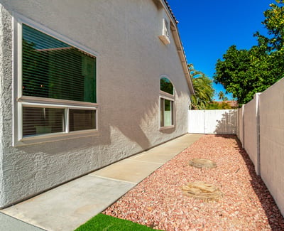 Side yard pathway with desert landscaping and gravel ground cover designed for easy upkeep. This Scottsdale outdoor area provides practical access around the home while maintaining a clean and organized appearance.