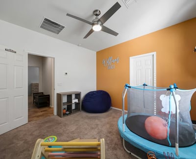 Well-sized bedroom with walk-in closet and ceiling fan, offering flexible space for guests, family, or a home office.