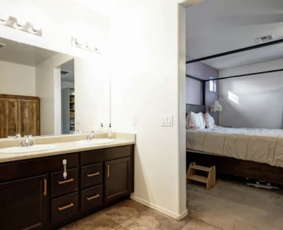 Primary bath showcasing a dual vanity with ample storage, clean lines, and modern finishes designed for daily comfort.