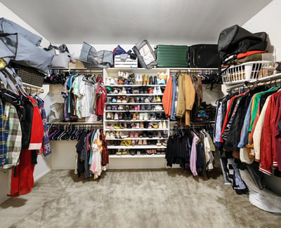 Primary closet featuring extensive shelving and hanging areas, ideal for organized storage and easy access.