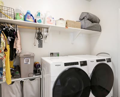 Laundry room with shelving and appliance space, designed to keep daily routines organized and efficient.