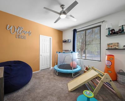 Fourth bedroom with comfortable layout and ceiling fan, easily adaptable to guest use or everyday living.