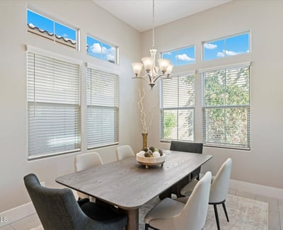 Bright formal dining space with high ceilings and elegant lighting, positioned to complement the open kitchen and living areas.