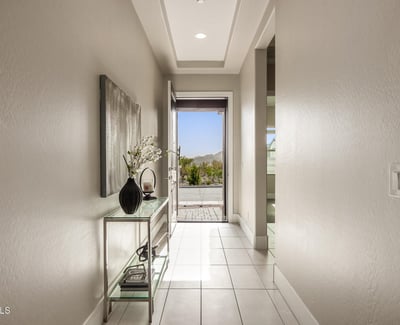 Light-filled entry hallway with tile floors and contemporary finishes, setting the tone for the home s open and modern layout.