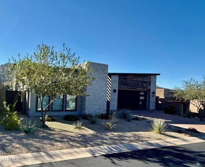 Front exterior highlighting contemporary architecture, desert landscaping, and clean modern lines in a prestigious Scottsdale neighborhood.