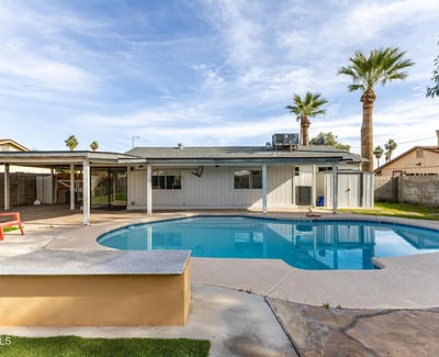 Spacious backyard with private pool, covered patio, and open lounging areas an ideal setting for gatherings and relaxed Phoenix outdoor living.