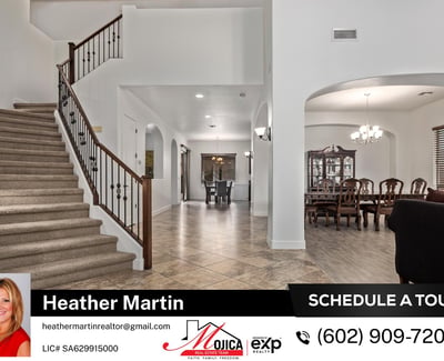 This grand entry showcases vaulted ceilings, tile flooring, and a staircase with iron accents. The open floor plan connects seamlessly to the formal dining area, ideal for entertaining.