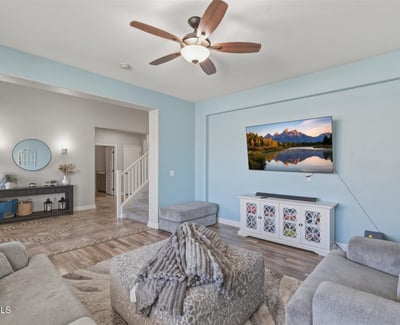 View from the living room toward the open entryway, showcasing the spacious layout, tall ceilings, and modern finishes throughout the home.