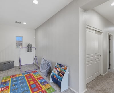 Upstairs loft and hallway connecting to bedrooms and bathrooms, providing additional living space perfect for family activities.