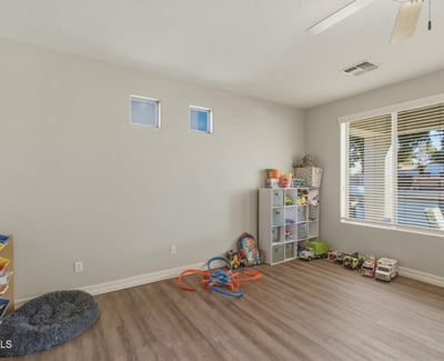 Spacious bonus room with wood-style flooring and natural light, offering flexible space for a playroom, office, or additional living area.