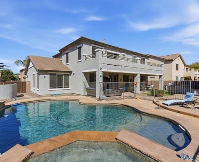Resort-inspired backyard with freeform pool, raised spa, and spacious decking ideal for relaxing, swimming, and entertaining guests.