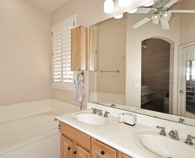 Primary bath with dual vanities, soaking tub, and abundant counter space. This Phoenix home features practical design, natural light, and comfortable finishes.