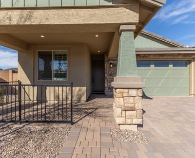 Charming front porch with architectural columns and shaded entry, creating an inviting first impression for this upgraded Peoria residence.