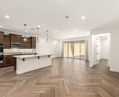 Large open great room with designer tile flooring and recessed lighting, offering a seamless layout for entertaining and modern living.
