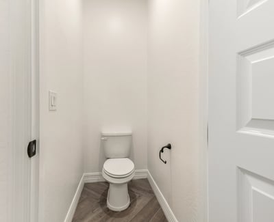 Private water closet providing additional comfort and separation within the primary bathroom.