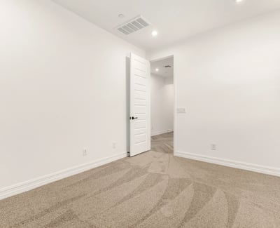 Bright bedroom featuring neutral finishes, soft carpet, and energy-efficient window coverings for a comfortable atmosphere.