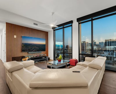 Open living area filled with natural light, featuring floor-to-ceiling windows and panoramic Phoenix views, perfect for modern indoor-outdoor living.