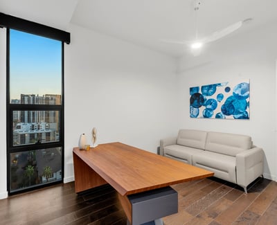 Contemporary room ideal for remote work or guest accommodations, with clean design, updated flooring, and bright Phoenix views.